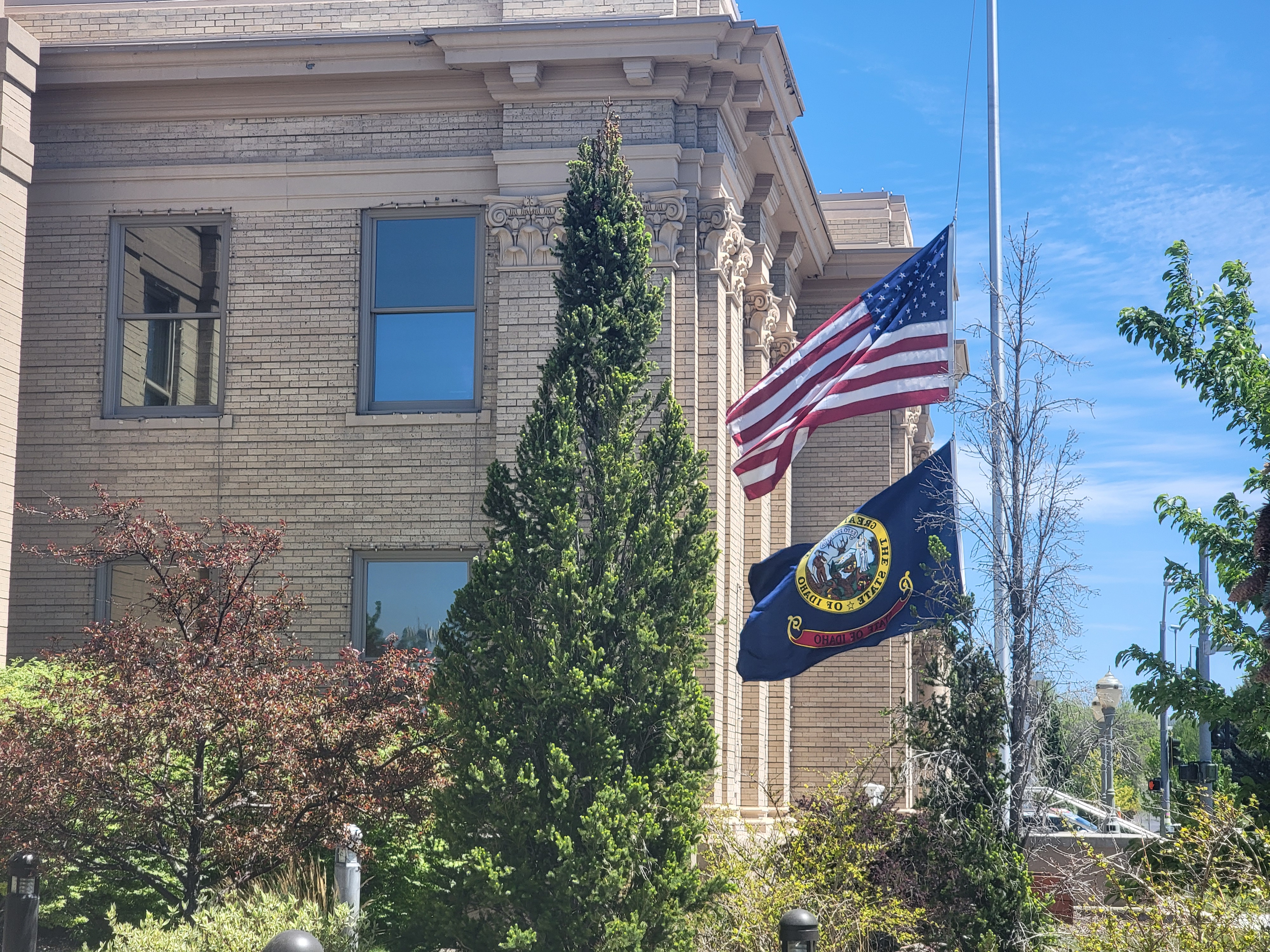 Current image: Madison County Courthouse in Rexburg Idaho with American and Idaho state flags